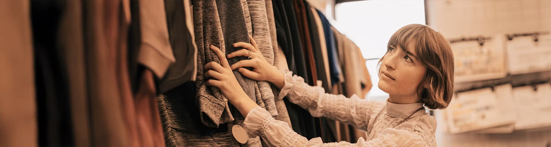 student looking through clothes on a rack