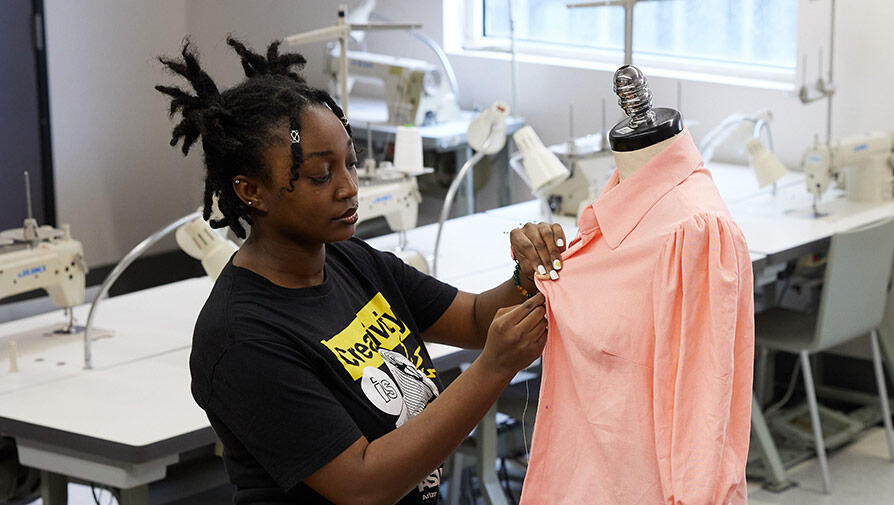 Student sewing a shirt